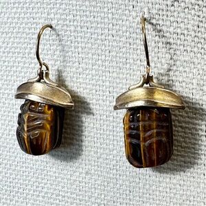 This is a vintage Egyptian revival carved tiger's eye scarab earring
